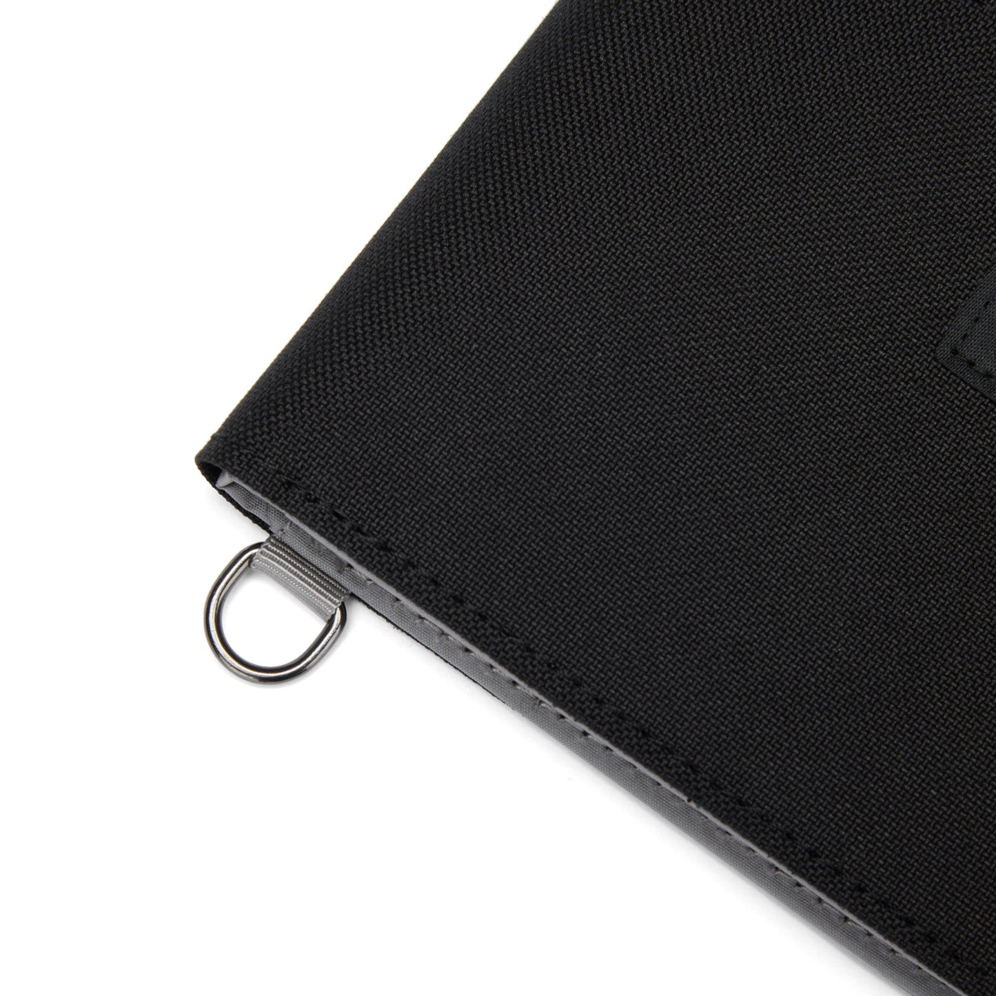Close up of black Pacsafe® RFIDsafe™ RFID Blocking Bifold Wallet corner with security ring.