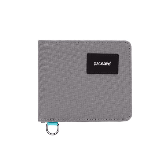 Product Image – Slim Pacsafe® RFIDsafe™ stone grey wallet with RFID blocking, a black logo patch, and metal ring loop.