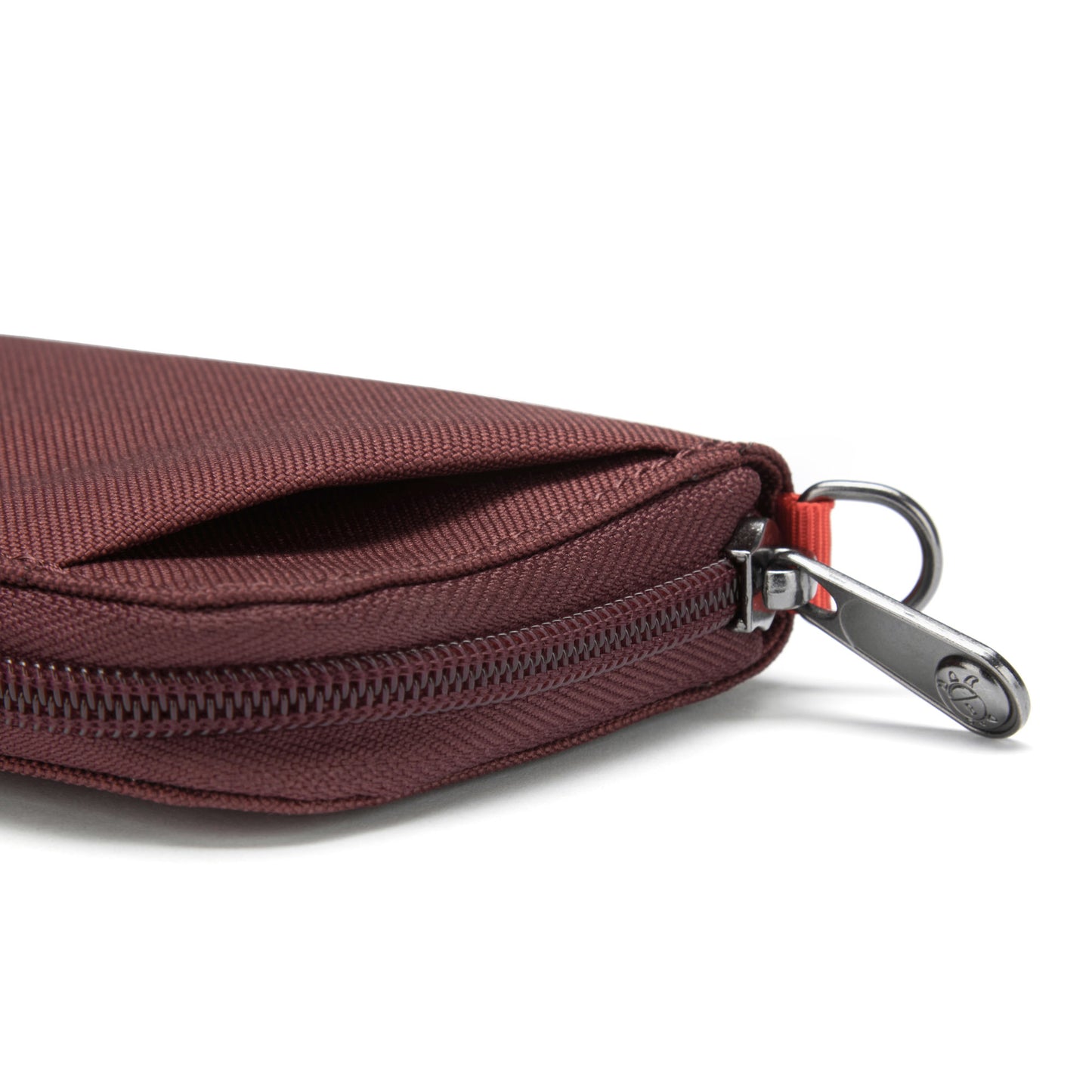 Close-up of the Pacsafe® RFIDsafe™ wallet, made from recycled polyester with a metal zipper pull.