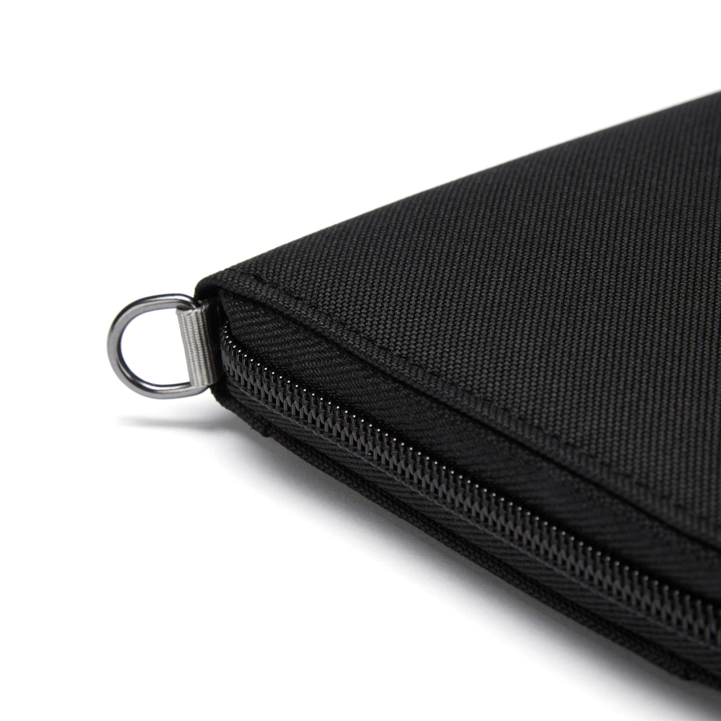 Close-up of a Pacsafe® RFIDsafe™ Travel Organizer corner with metal ring on a white background.