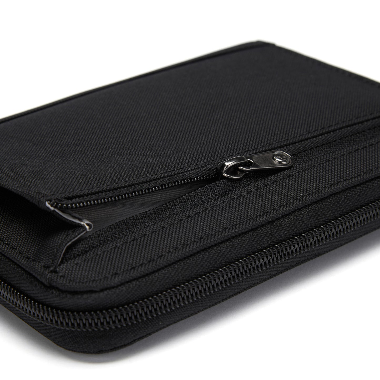 Close-up of partially opened Pacsafe® RFIDsafe™ Travel Organizer, showcasing its black texture and stitching.