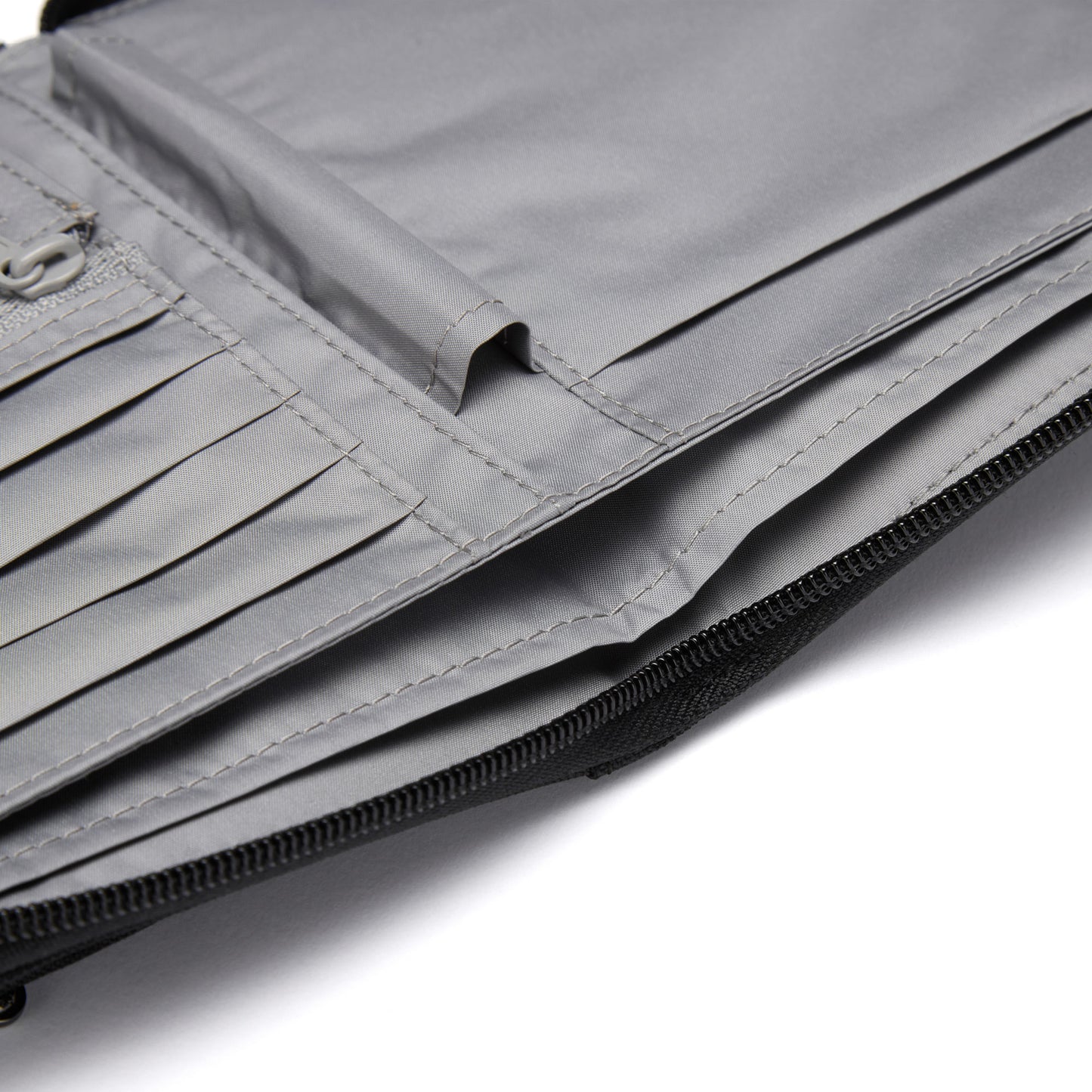 Close-up of Pacsafe® RFIDsafe™ Travel Organizer with RFID blocking, card slots, and a zipper compartment.