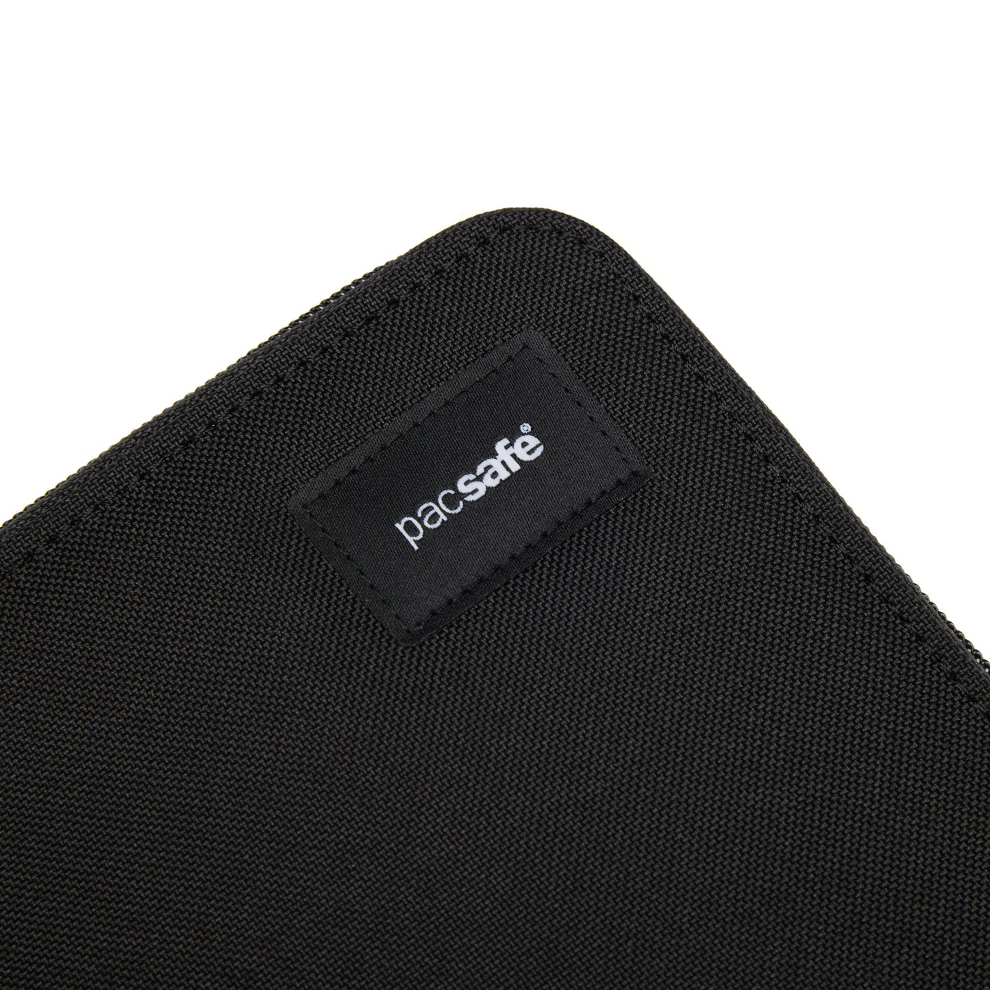 Close-up of black Pacsafe® RFIDsafe™ logo label on a recycled polyester travel organizer.