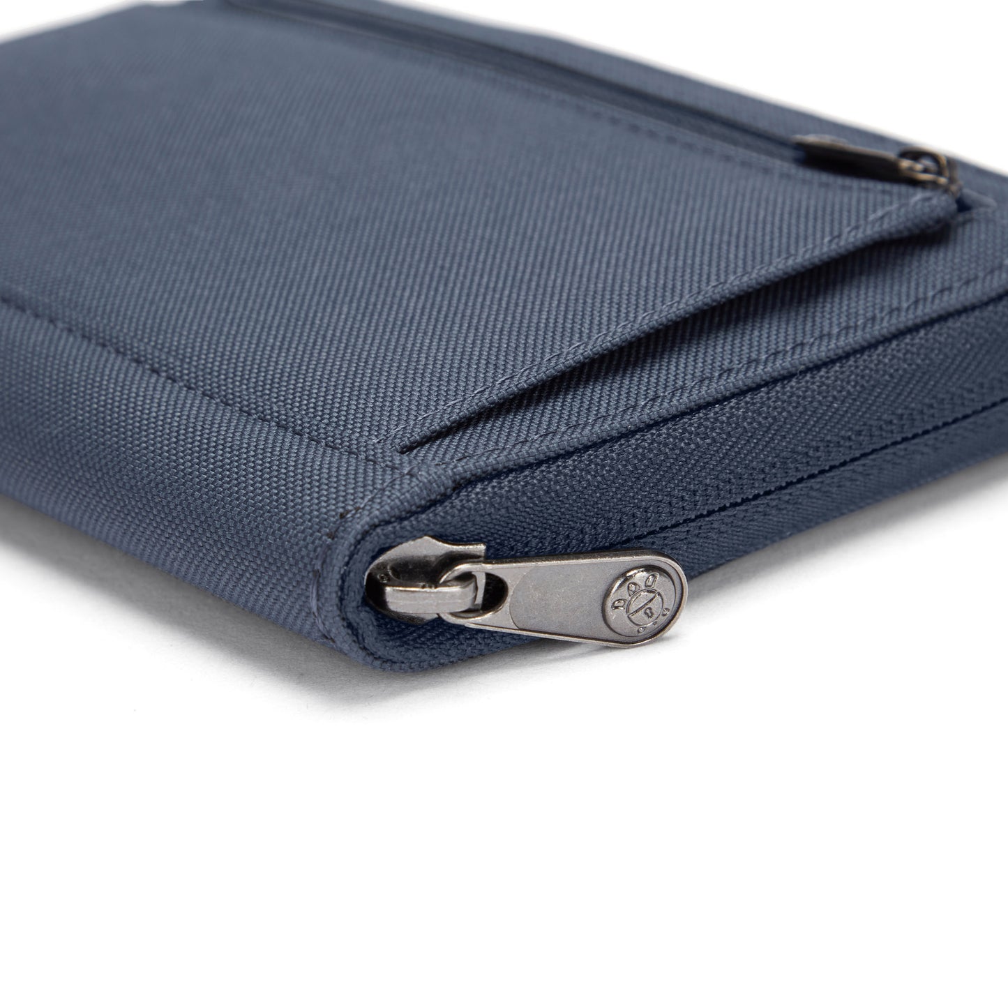Close-up of a Pacsafe RFIDsafe blue travel organizer with RFID blocking and visible zipper.
