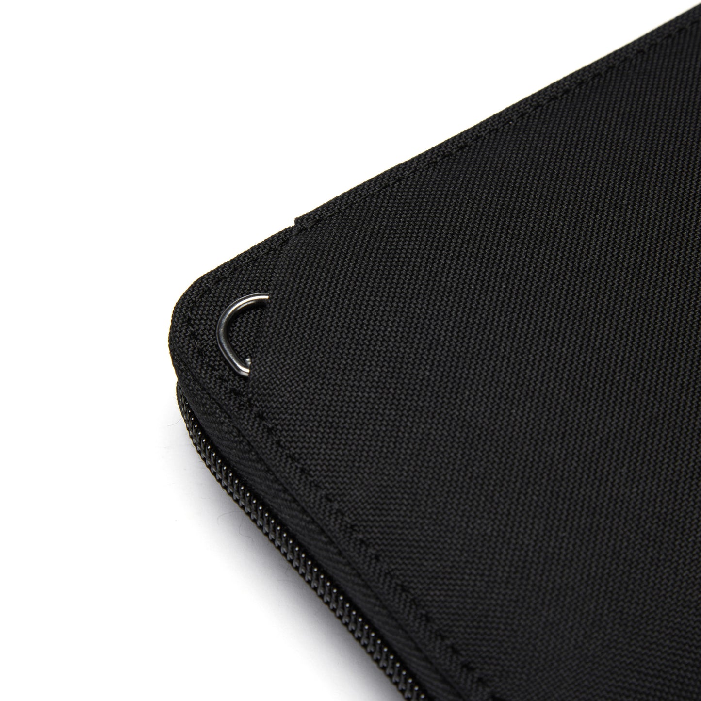 Close-up of a Pacsafe® RFIDsafe™ Wallet, black RFID-blocking fabric with a metal ring attachment.