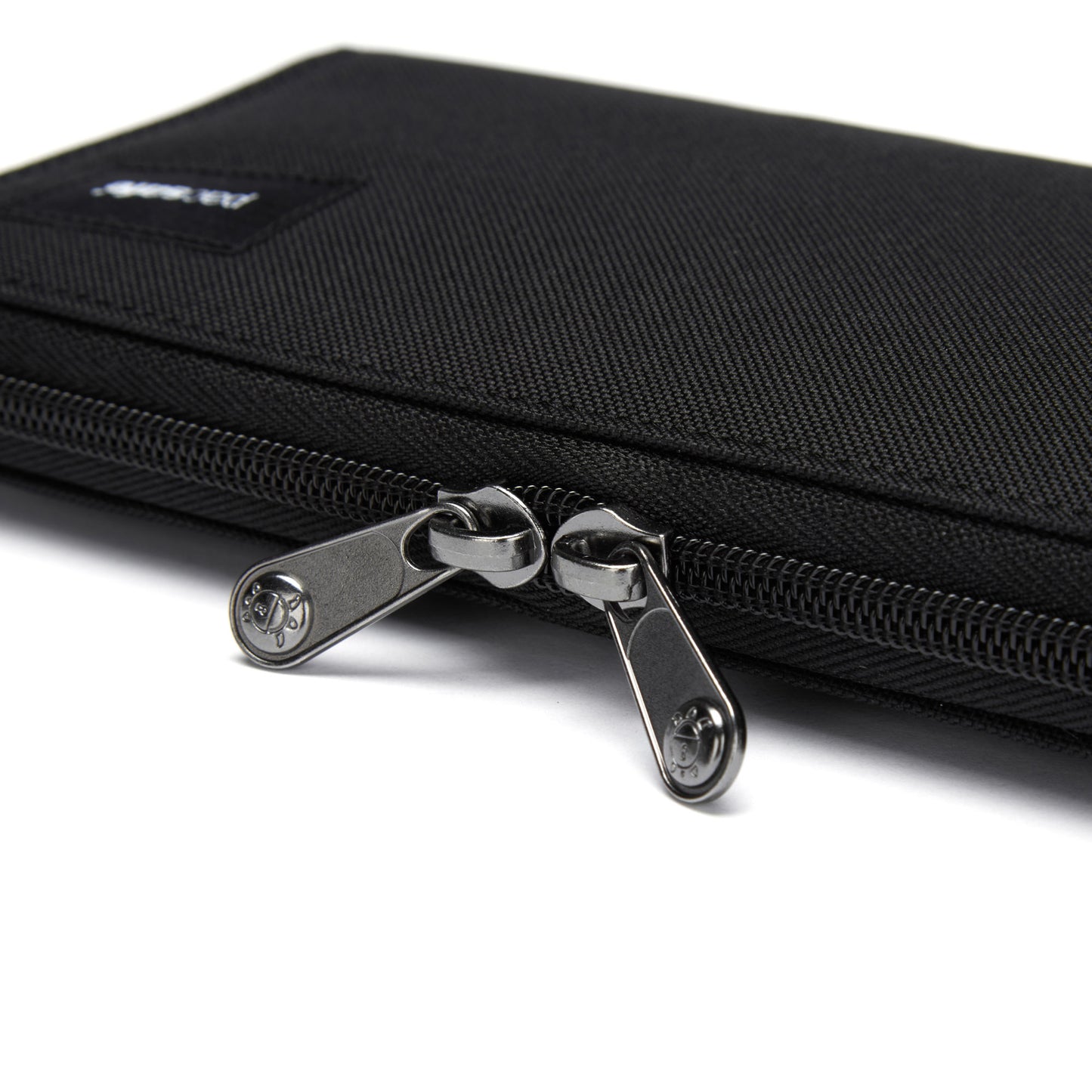 Pacsafe® RFIDsafe™ Continental Wallet: Black recycled polyester case with center-closed dual metal zippers.