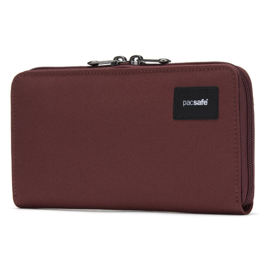 Product Image – A garnet red RFID-blocking wallet with a zipper and black Pacsafe® logo patch.