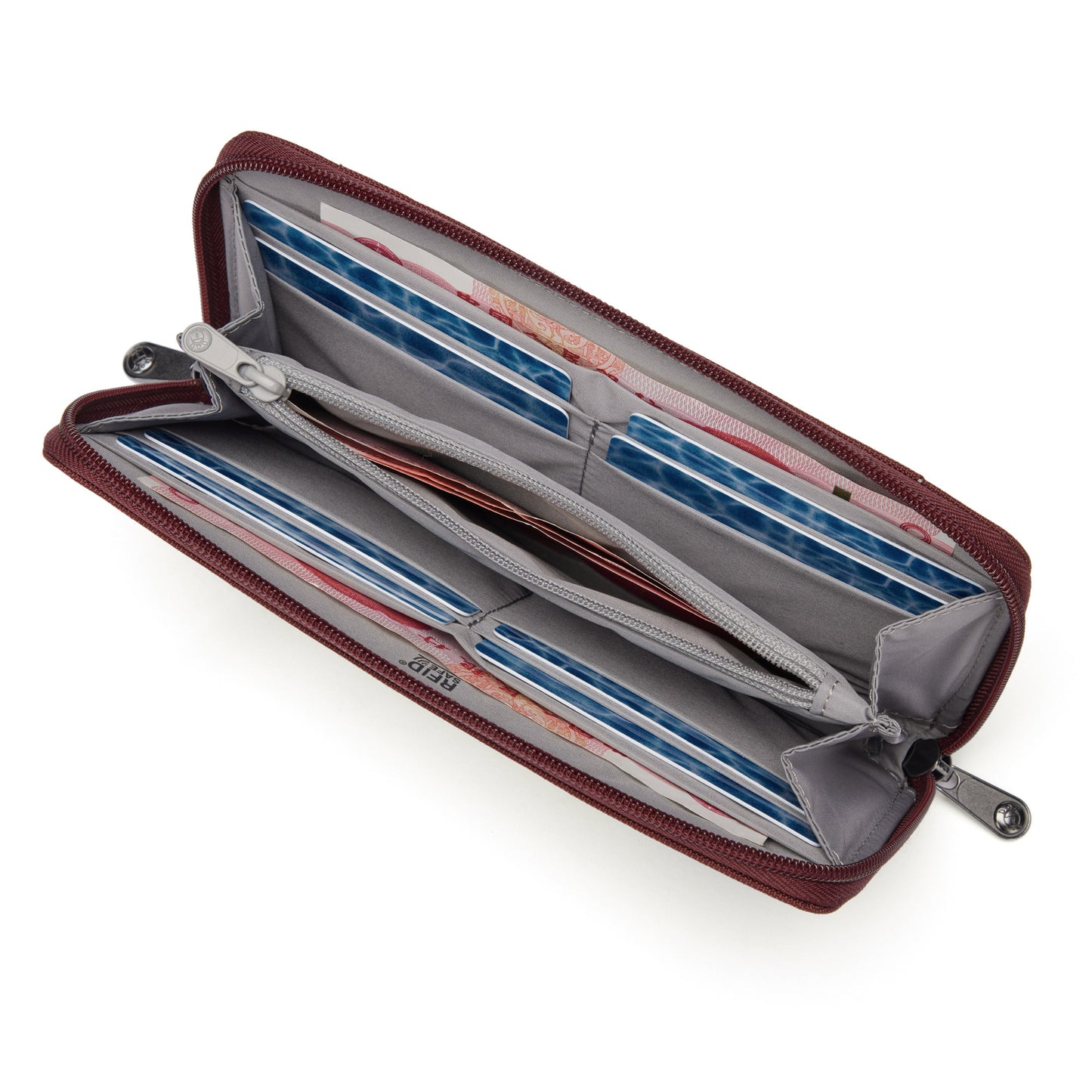 Open Pacsafe® RFIDsafe™ wallet in garnet red, featuring RFID-blocking and multiple compartments to hold cash and cards, against a white background.