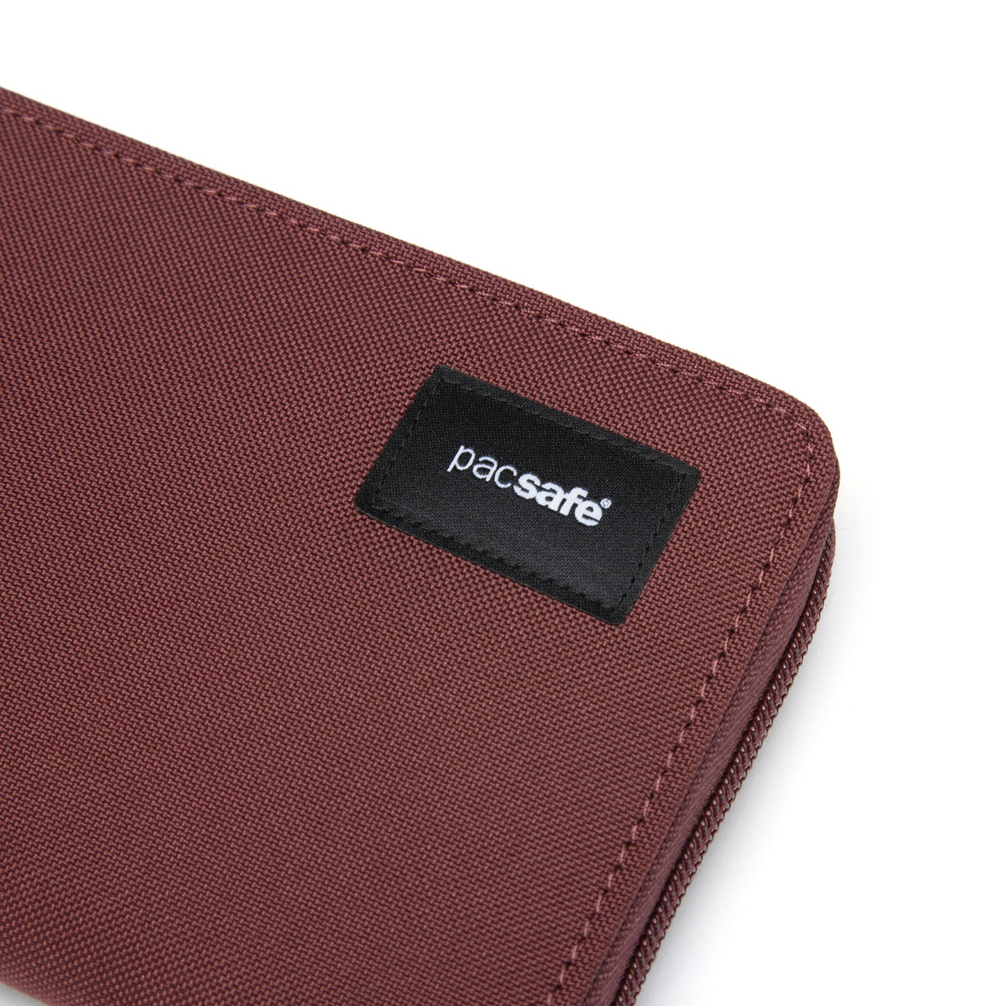 Close-up of a garnet red Pacsafe® RFIDsafe™ RFID-blocking wallet with black label.