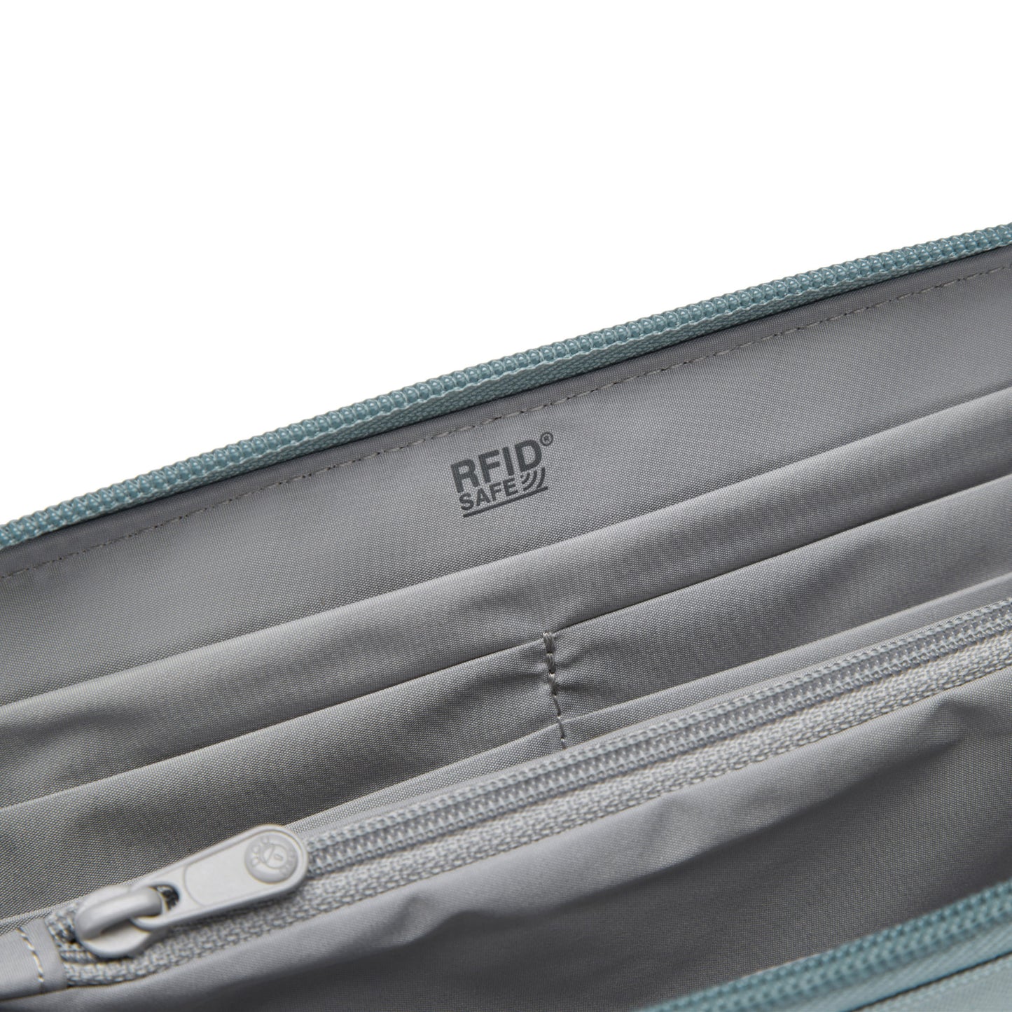 Inside view of grey interior lining of fresh mint Pacsafe® RFIDsafe™ RFID Blocking Continental Wallet with RFID card slots and zippered pocket.