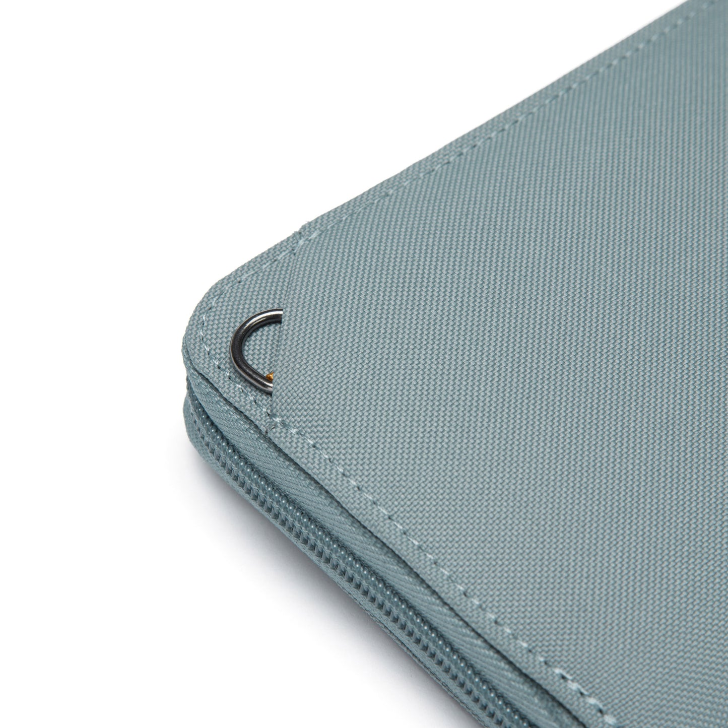 Close up of metal attachment ring on back of fresh mint Pacsafe® RFIDsafe™ RFID Blocking Continental Wallet