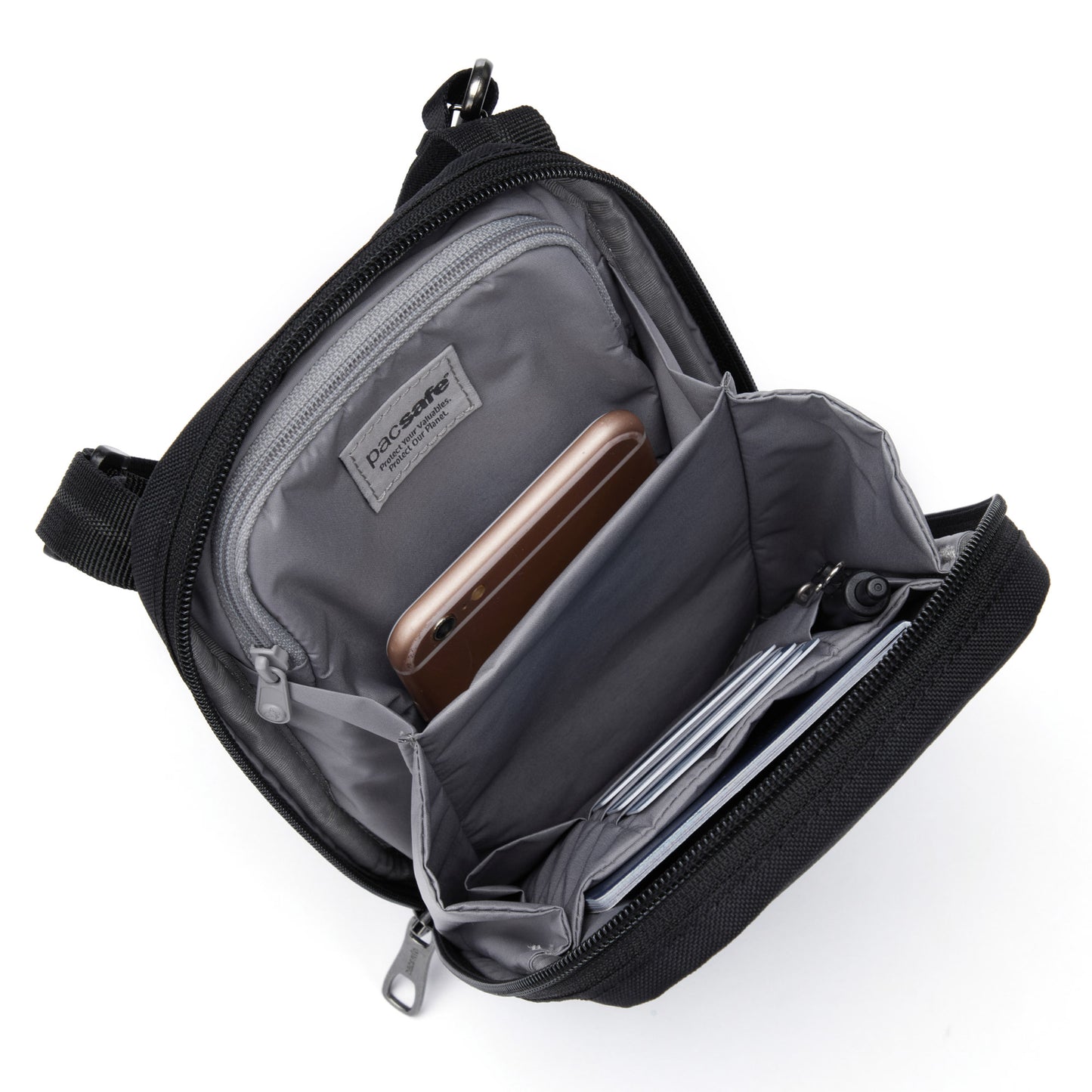 Open Pacsafe® RFIDsafe™ crossbody bag with RFID-blocking, featuring separate compartments for phone and wallets.