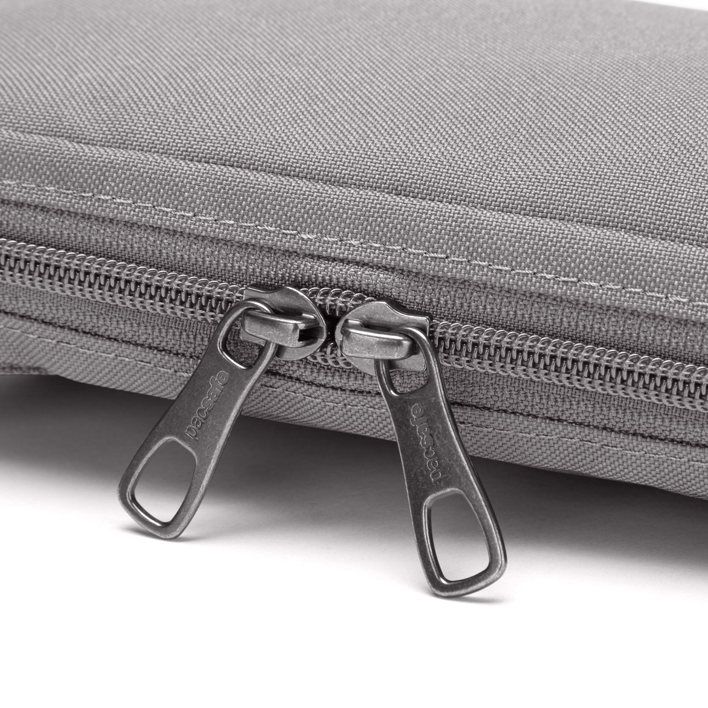 Close up of double zipper pulls on stone Pacsafe® RFIDsafe™ RFID Blocking Tech Crossbody