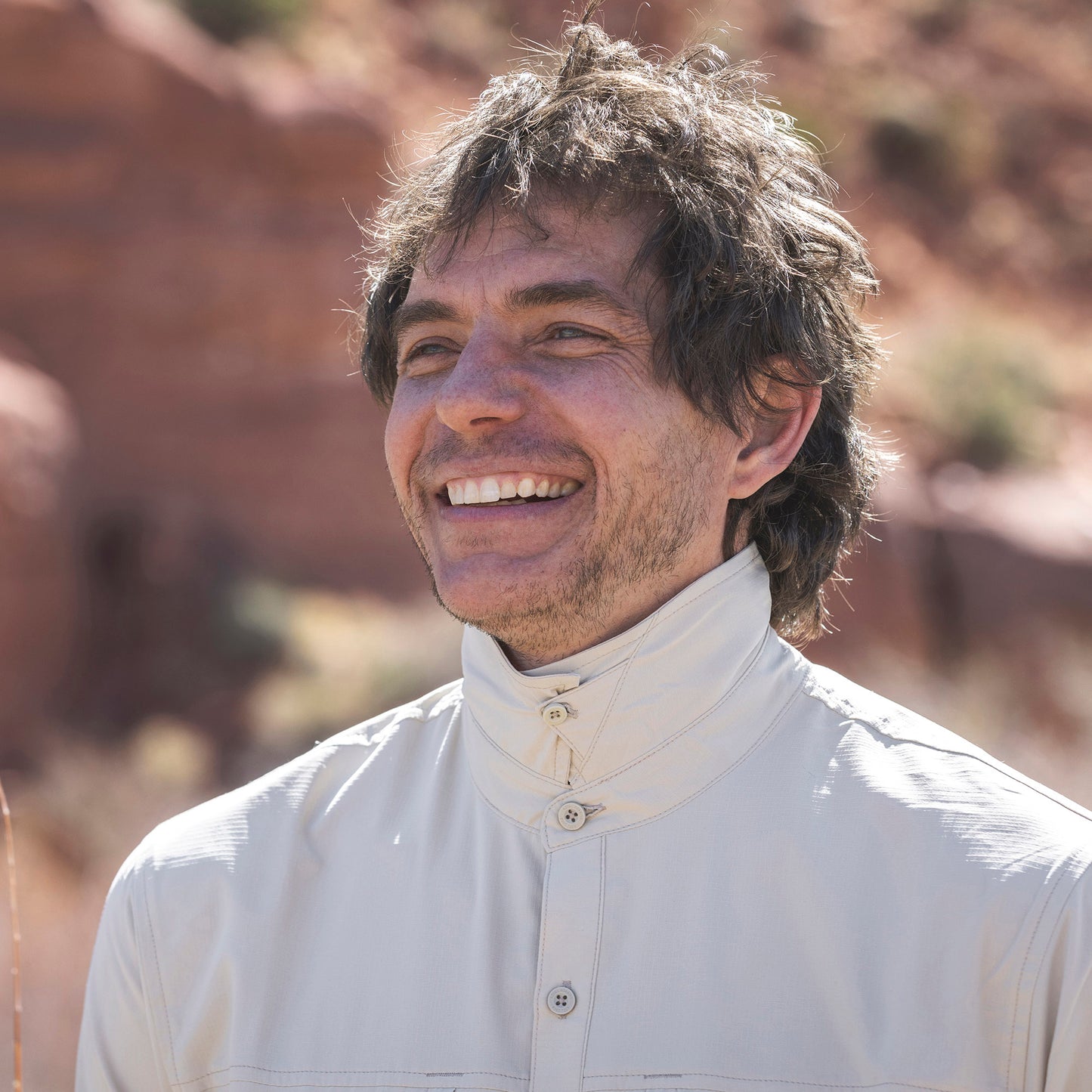 Lifestyle image of man wearing Royal Robbins Expedition III long sleeve shirt with collar buttoned up to protect against mosquitos.