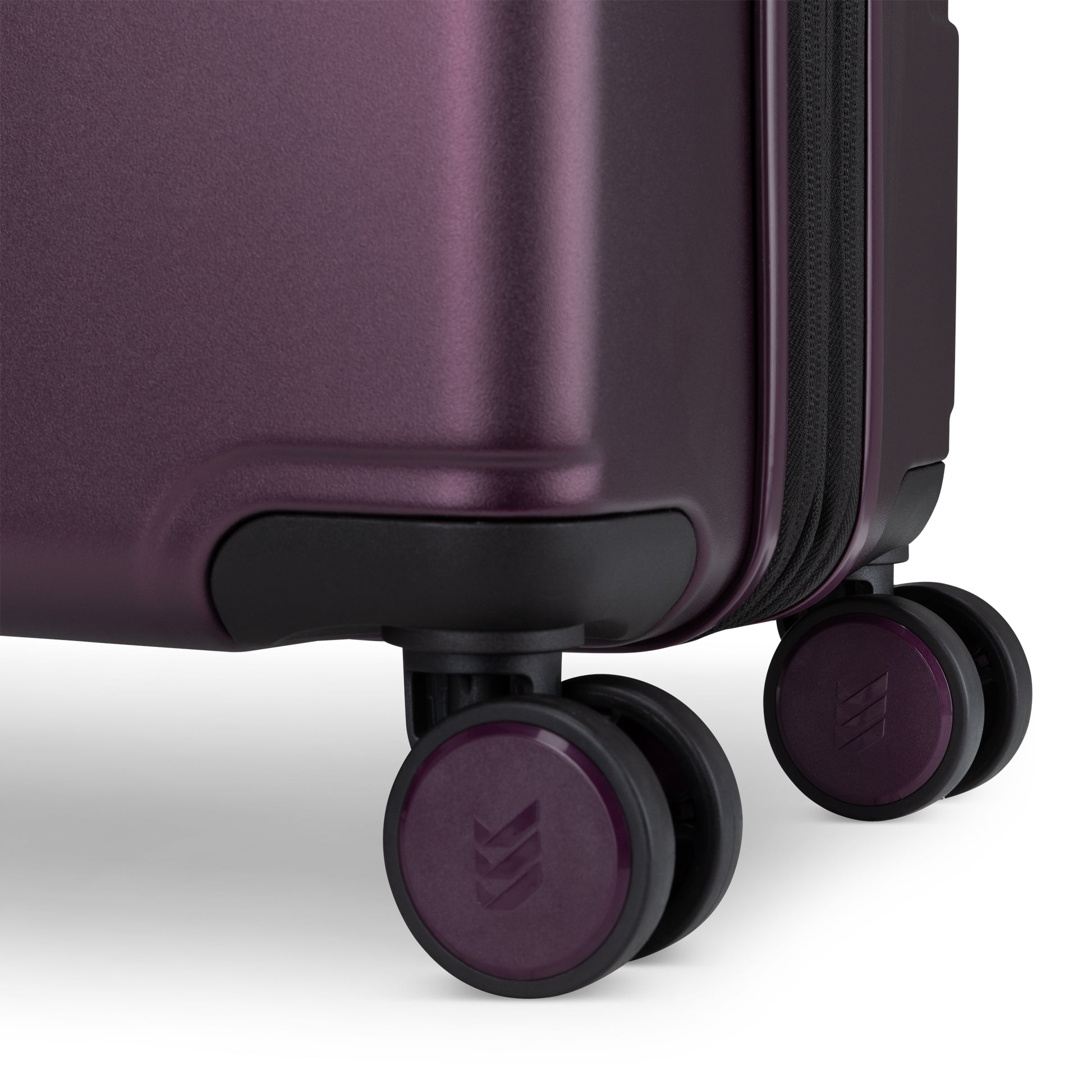 Close up of spinner wheels on fig purple Travelite Itinerary case.