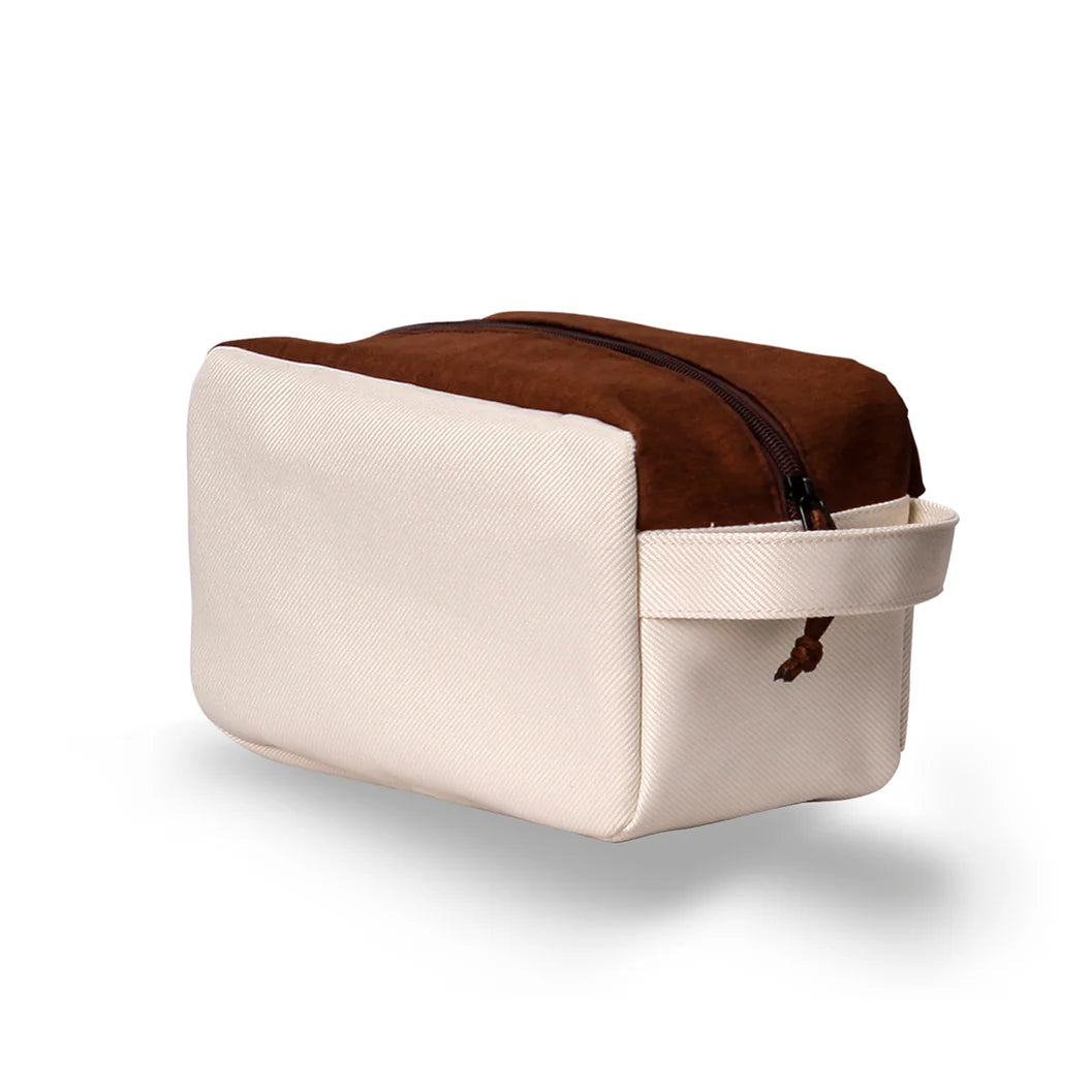 Northern Icons Canada Travel Toiletry Bag in beige and brown with zipper and handle, shown on white.
