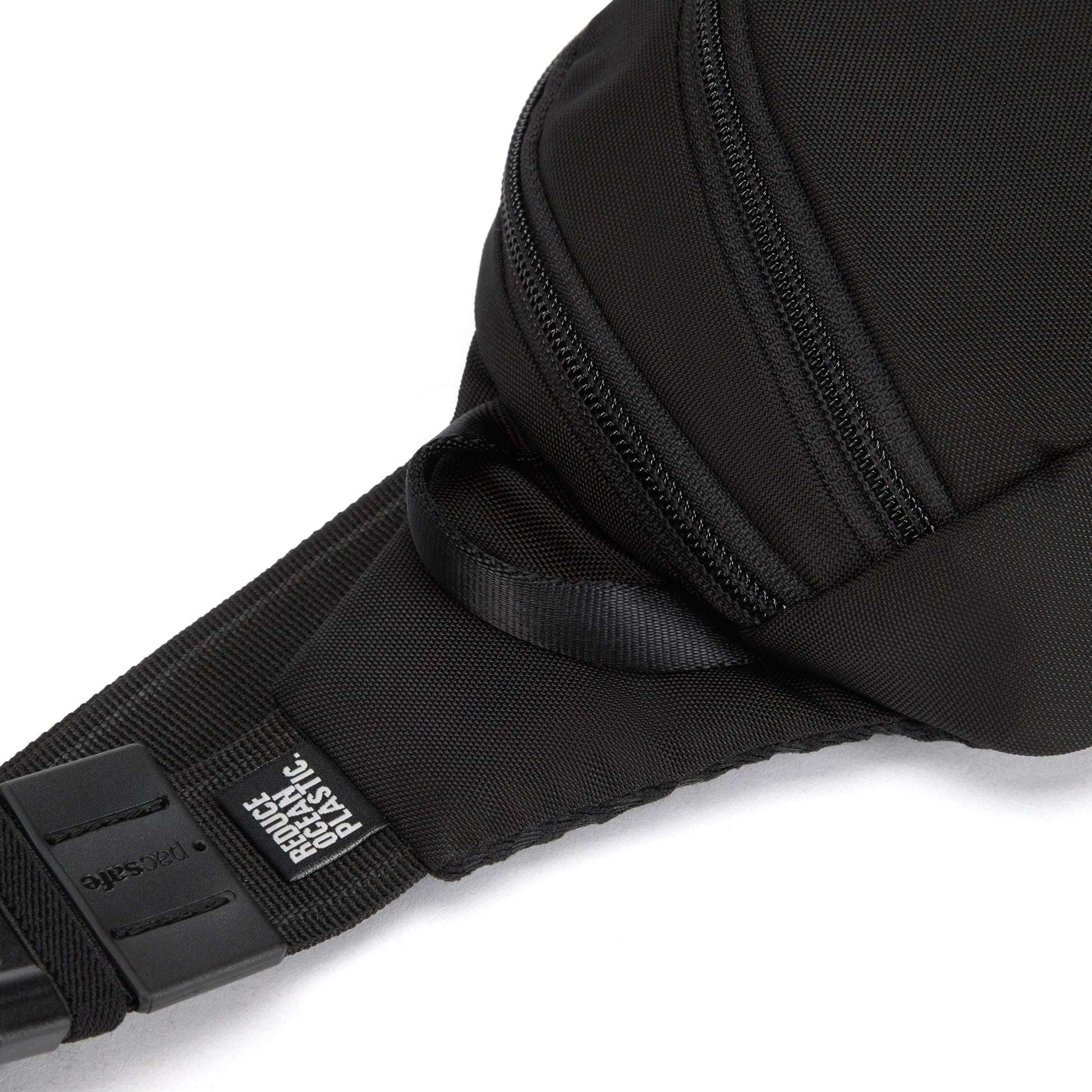 Close-up of the black Pacsafe® V Anti-theft Action Sling Pack with a side zipper and "reduce ocean plastic" tag.