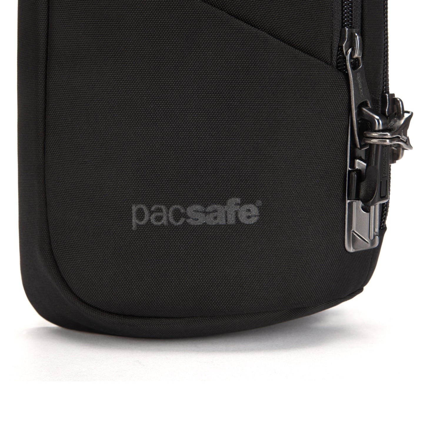 Close-up of Pacsafe® V Anti-theft Sling Pack with logo, metal zipper lock, and recycled polyester.