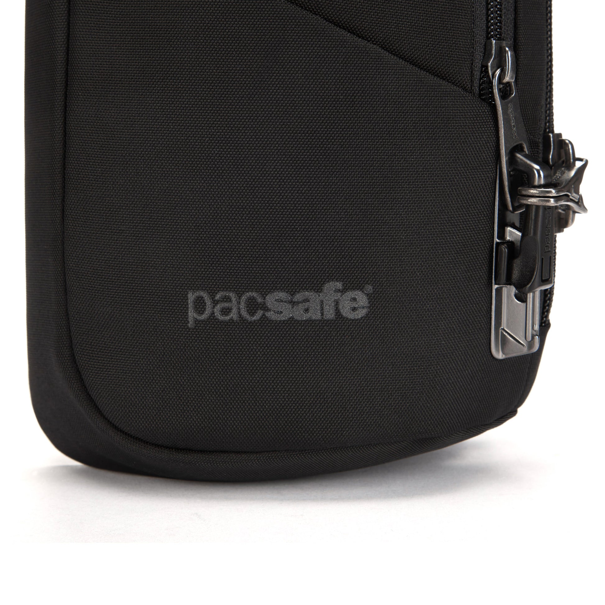 Close-up of Pacsafe® V Anti-theft Sling Pack with logo, metal zipper lock, and recycled polyester.