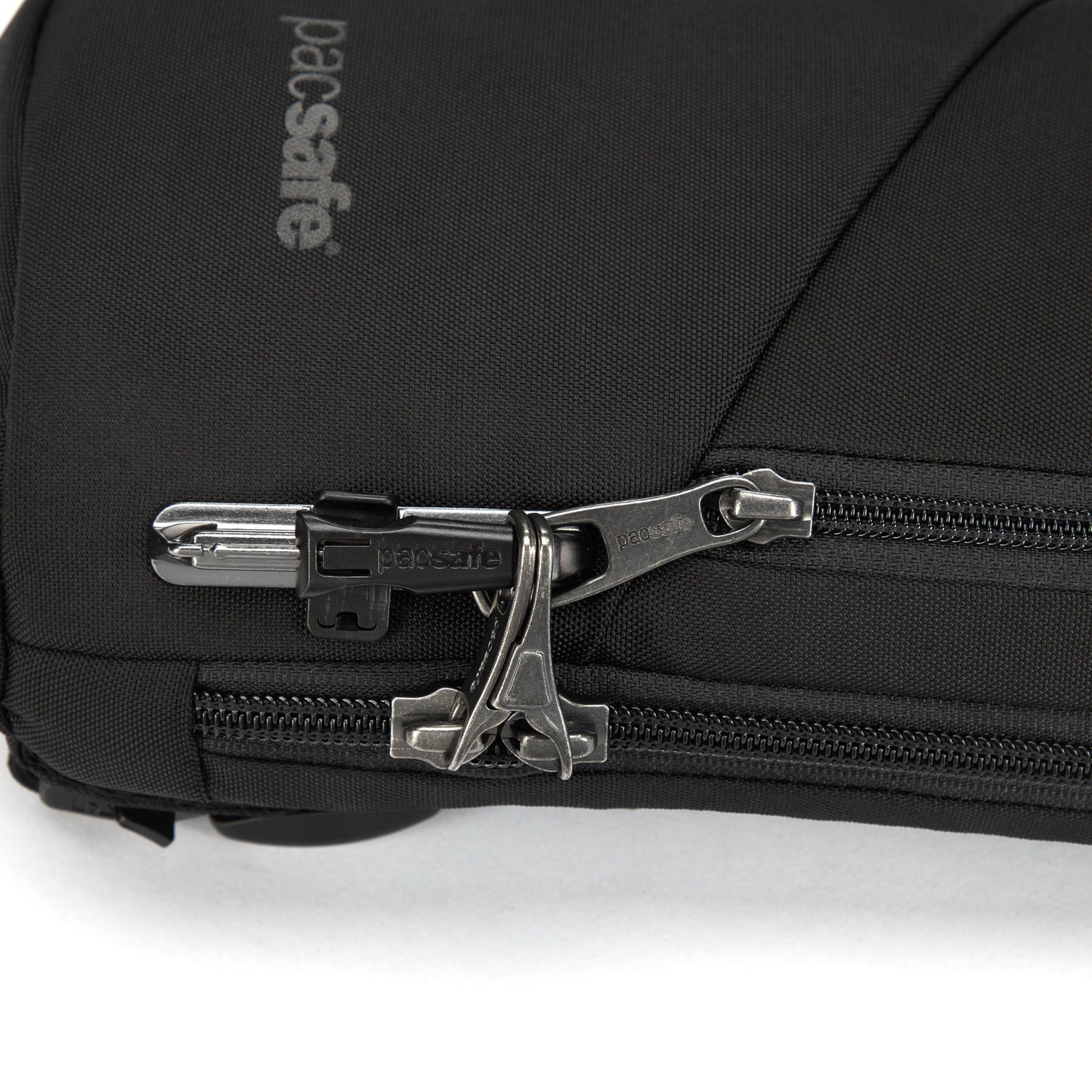 Close-up of a black Pacsafe® V Anti-theft Action Sling Pack made from recycled polyester, featuring a secure zipper.