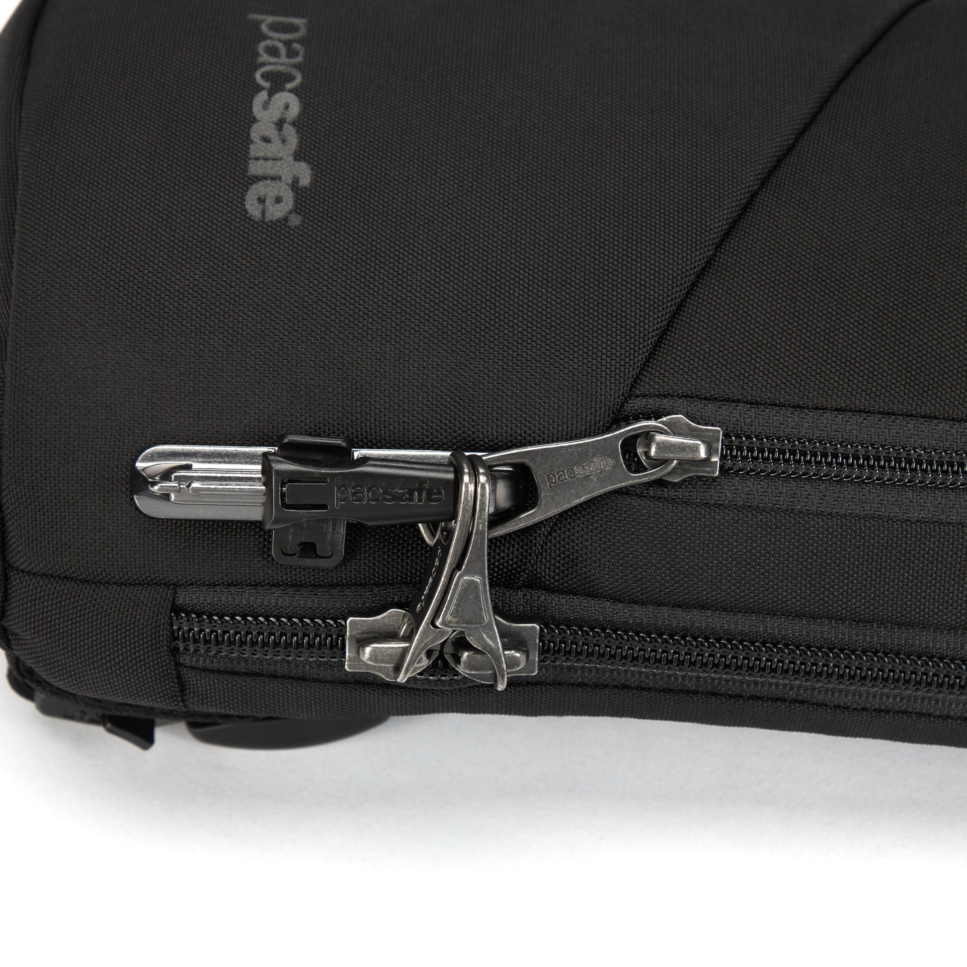 Close-up of a black Pacsafe® V Anti-theft Action Sling Pack made from recycled polyester, featuring a secure zipper.