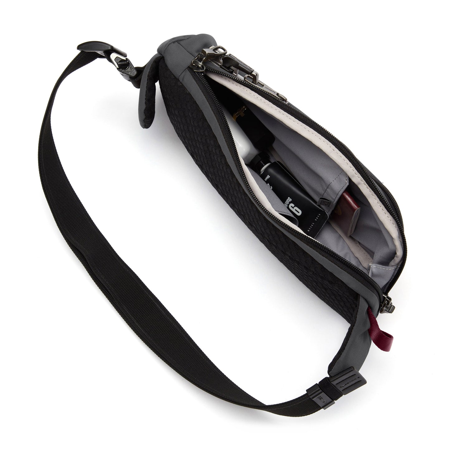 Open the Pacsafe® V Anti-theft Action Sling Pack, crafted from recycled polyester, to hold various small items.