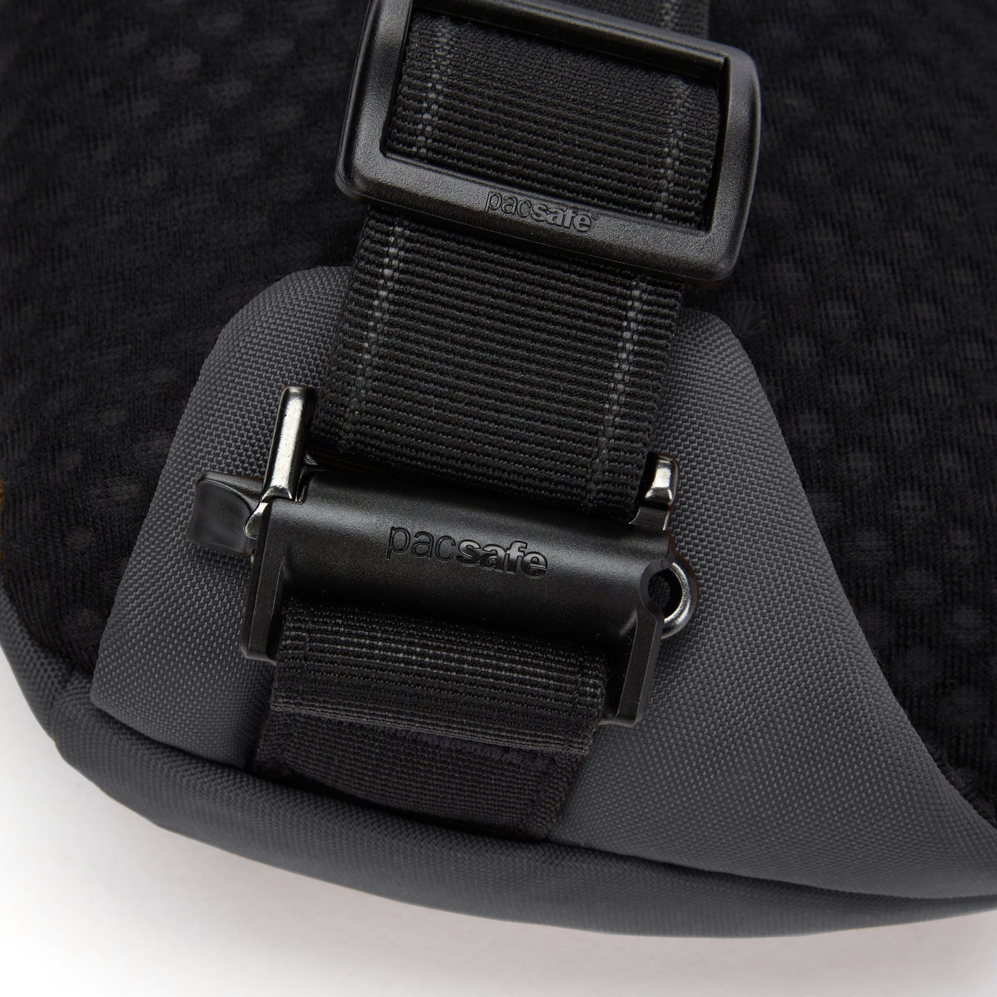 Close-up of the Pacsafe® V Anti-theft Sling Pack's secure buckle, made from recycled polyester.