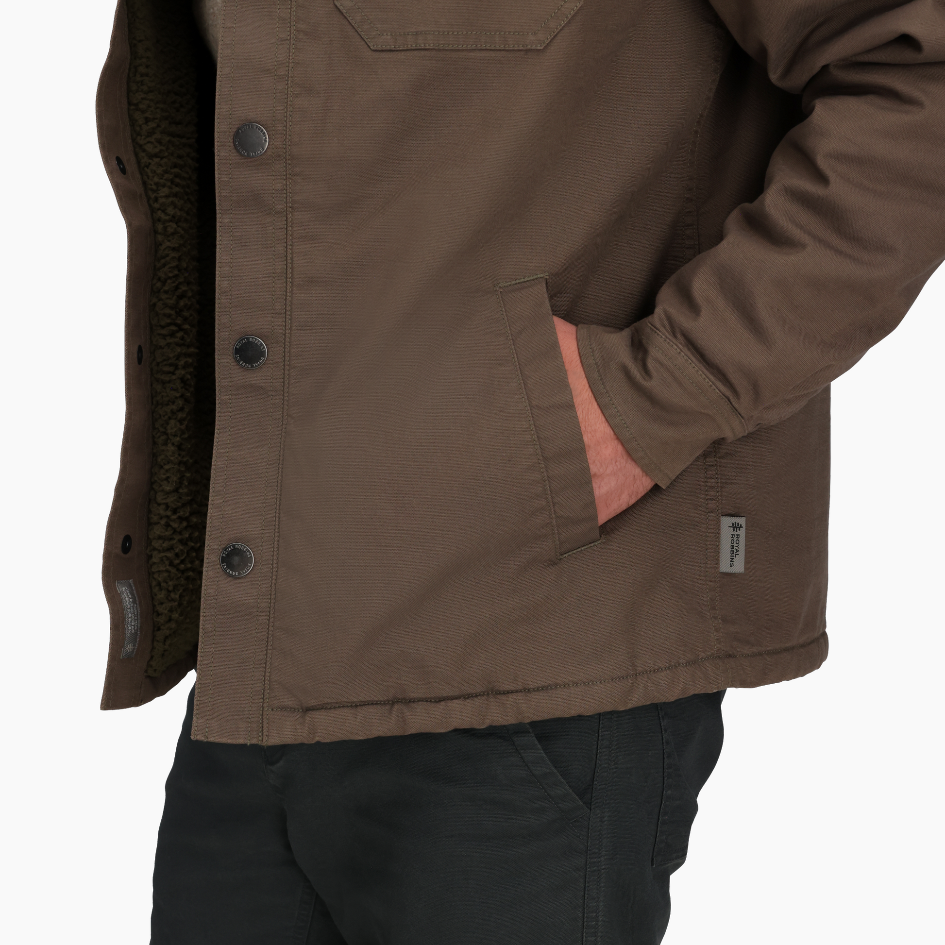 Man wearing Royal Robbins Men's El Cap Canvas Shacket with hand in pocket, against a plain white background.