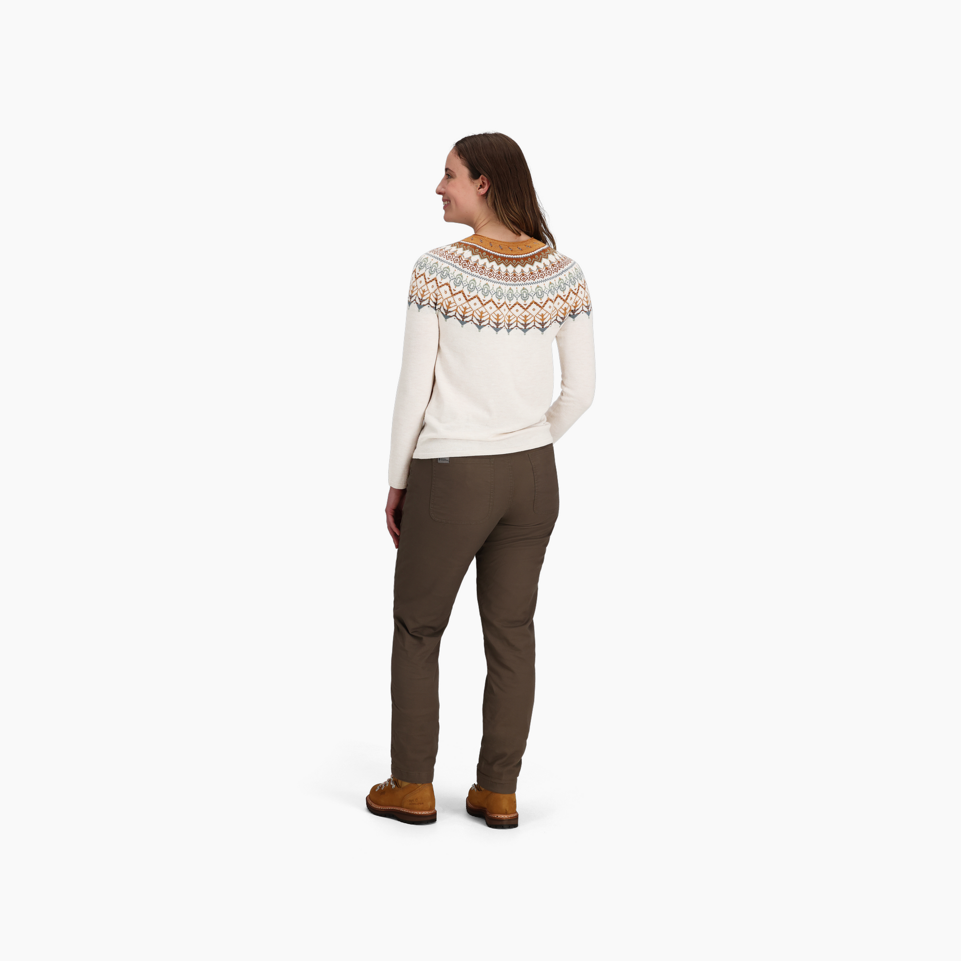 A woman faces away wearing the Royal Robbins Women's Westlands Fairisle Crew, channeling casual outdoor style.