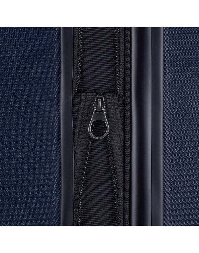 Bugatti Wellington Hardside 24" Expandable Spinner in Navy, close-up view of  zipper-release expansion system.