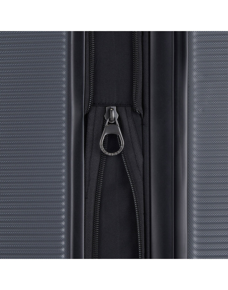 Bugatti Wellington Hardside Carry-on Spinner in Pewter colour, close up view of the zipper-release expansion system.
