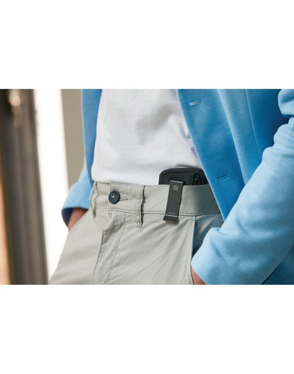 Lifestyle image of a person with hands in their pockets, Go Travel The Clip Pouch RFID clipped onto their jeans.