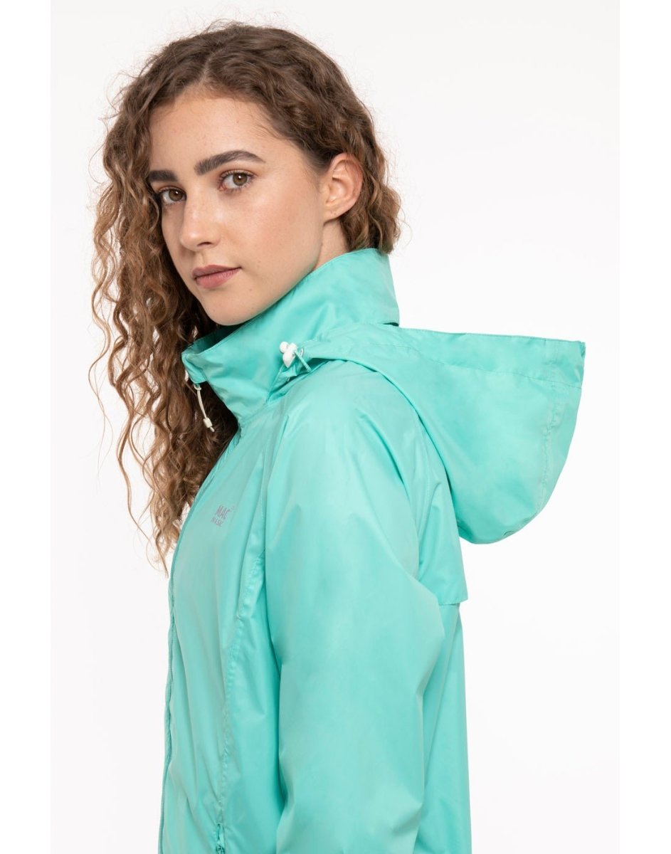 Woman wearing Mac in a Sac Origin II Packable Waterproof Jacket in tiffany, close up side view.