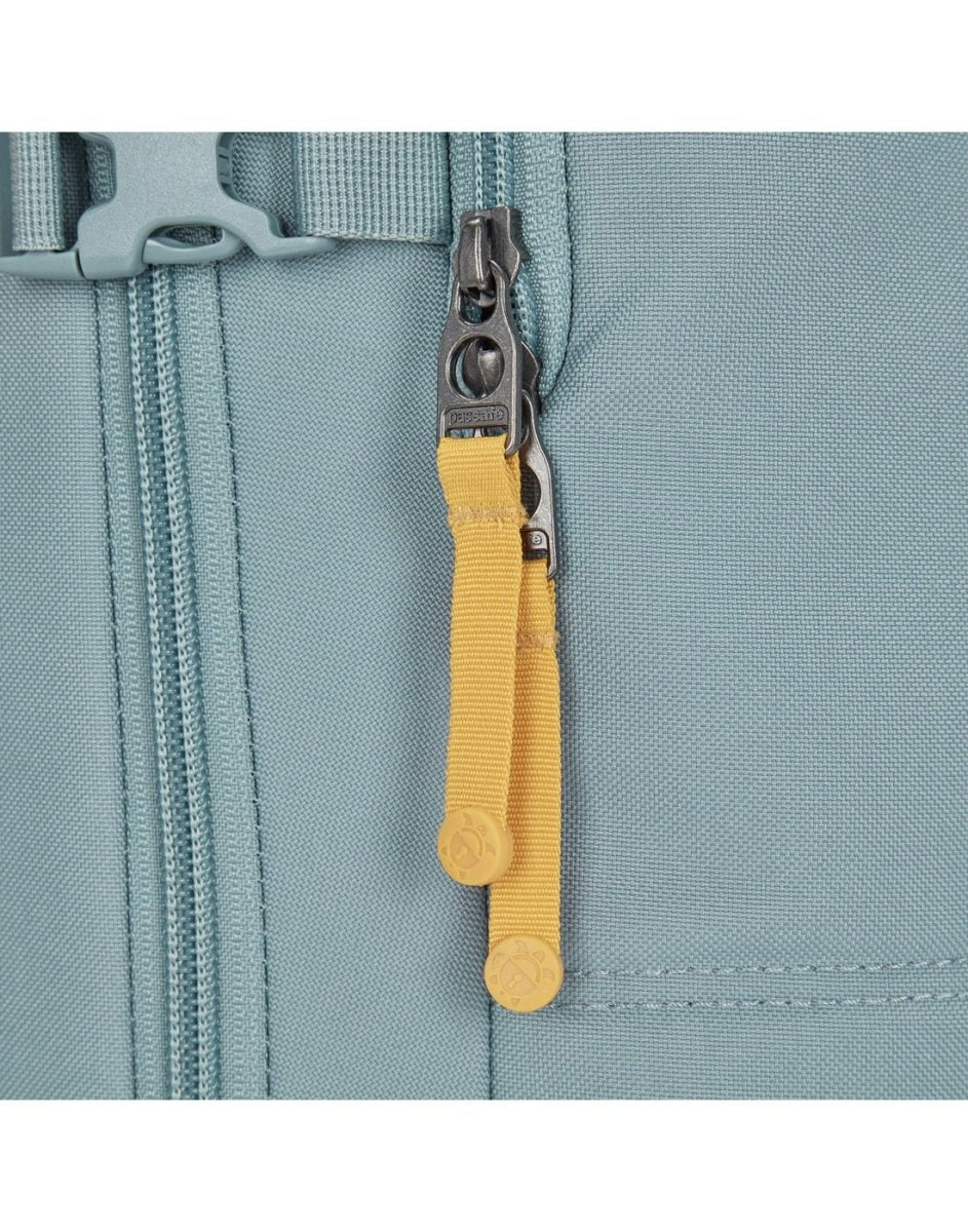 Close-up of a yellow zipper pull on the Pacsafe® GO 34L Anti-theft Carry-on Backpack in light blue.