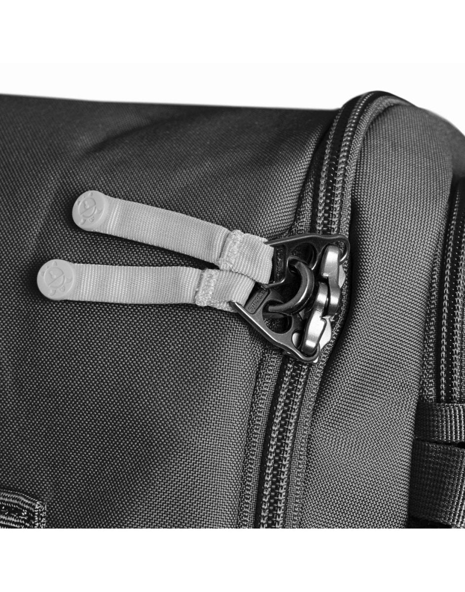 Close-up of Pacsafe® GO 34L Anti-theft Carry-on Backpack's lockable main compartment with dual pull tabs.