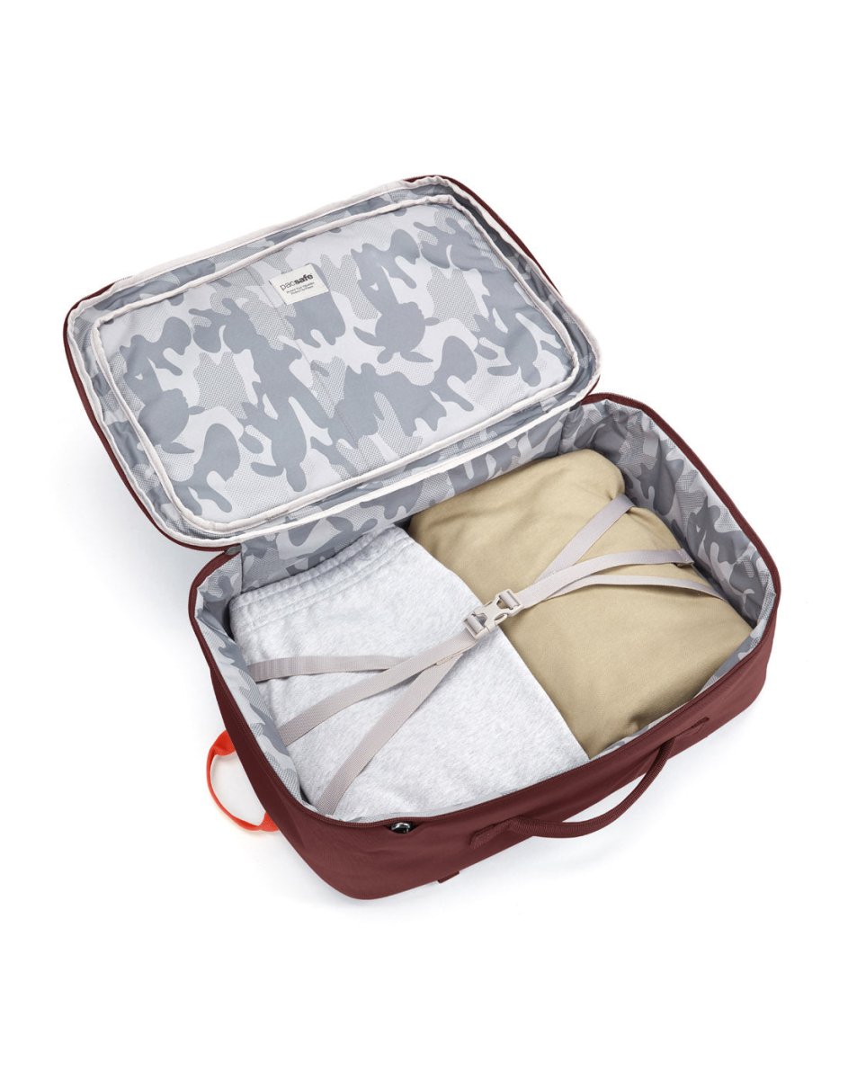 Pacsafe® GO 34L Anti-theft Carry-on Backpack: camo recycled polyester lining, secure straps, folded clothes inside.