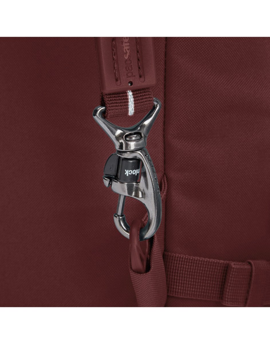 Close-up of a metal lock clasp on the maroon strap of the Pacsafe® GO 34L Anti-theft Carry-on Backpack.