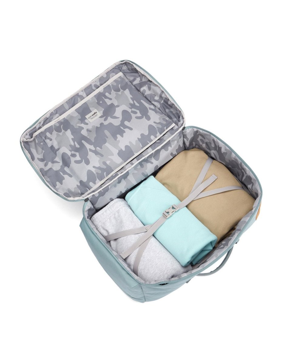 Pacsafe® GO 44L Anti-theft Carry-on Backpack with grey camo lining, folded clothes & travel pack secured inside.