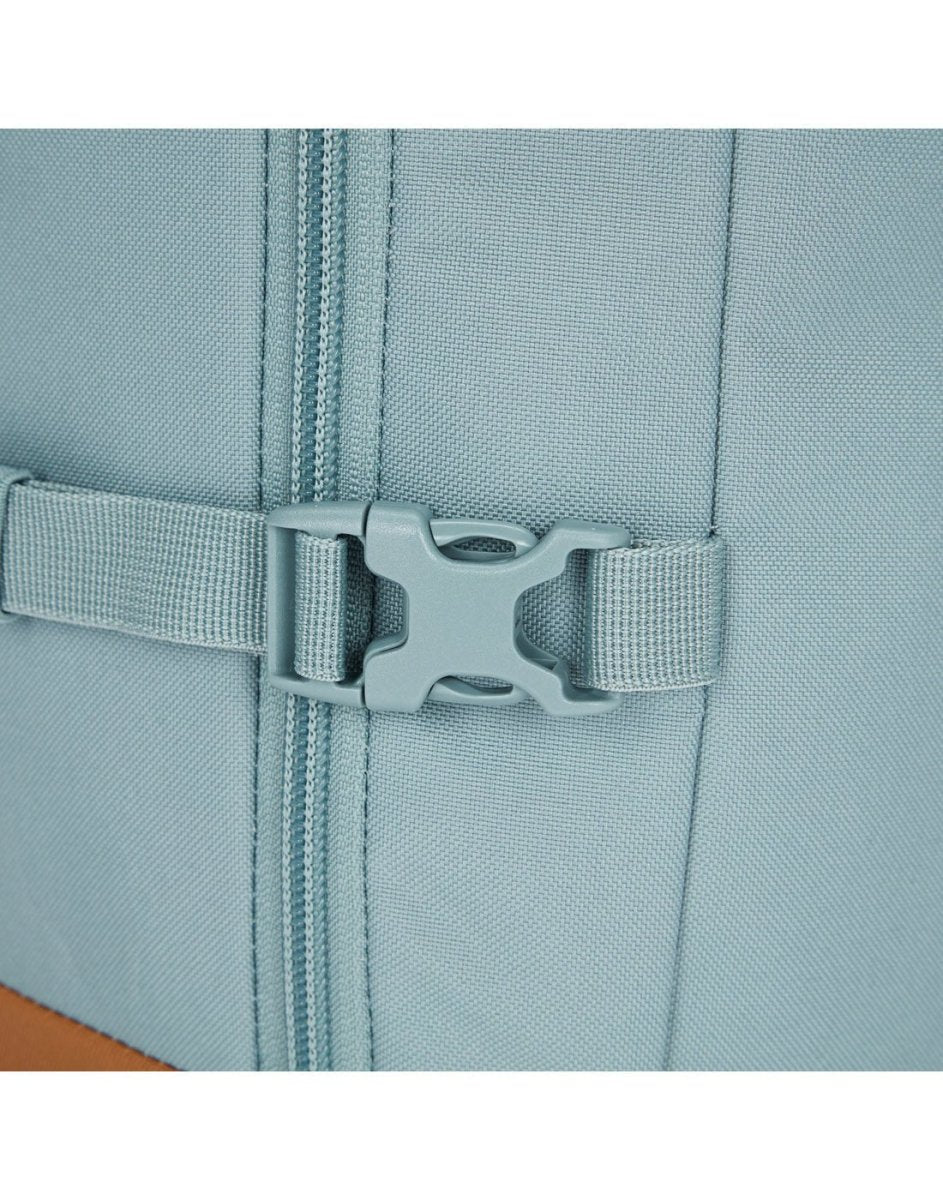 Close-up of the Pacsafe® GO 44L Anti-theft Carry-on Backpack in light blue with buckle and zipper.