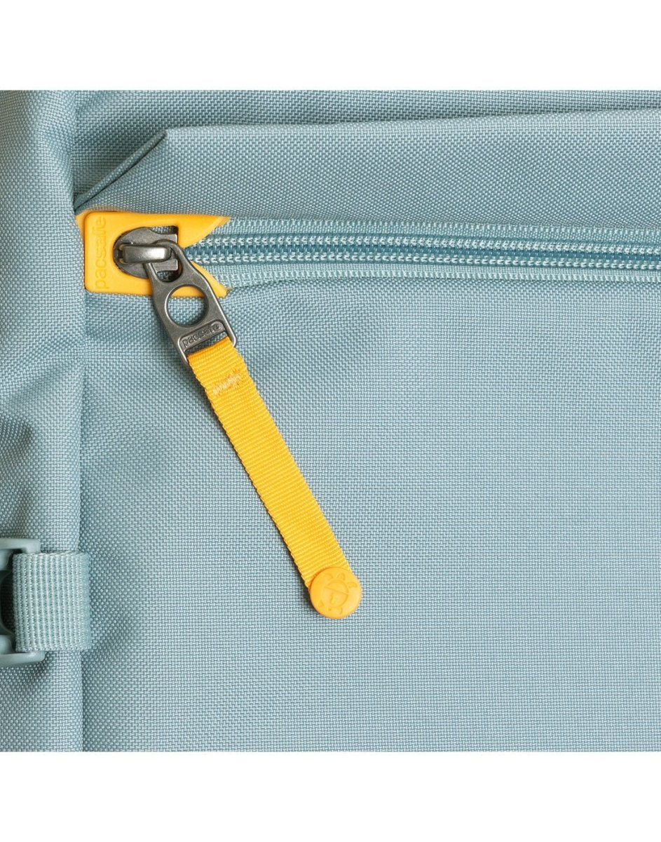 Close-up of the Pacsafe® GO 44L Anti-theft Carry-on Backpack in light blue with a yellow pull tab.