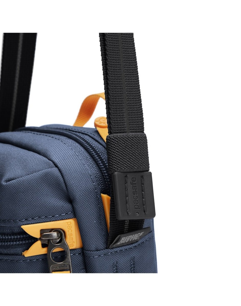 Pacsafe® GO Anti-Theft Micro Crossbody in coastal blue colour, close up of cut resistant shoulder strap and zipper with dock lock.