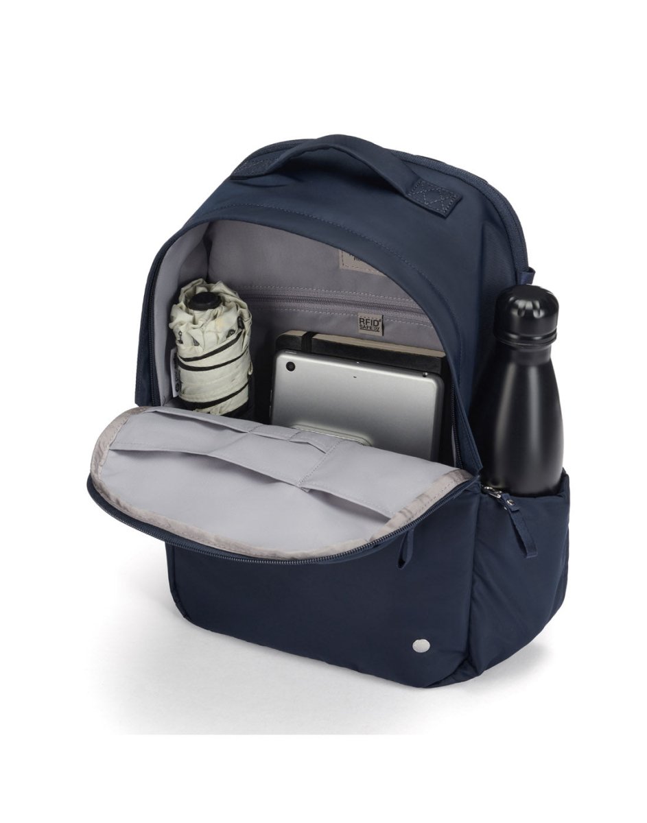 Open Pacsafe® W 10L navy anti-theft backpack showing umbrella, tablet, and water bottle inside.