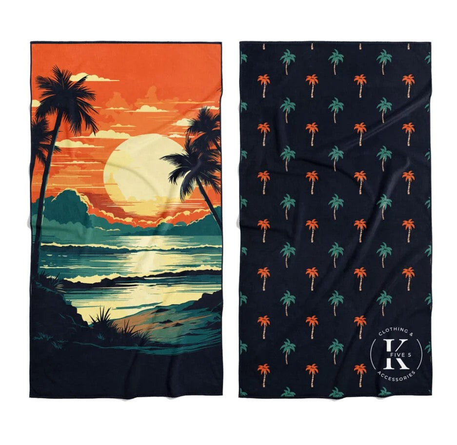 Two K5 Microfibre Beach Towels: one sunset scene, one black with small palm pattern.