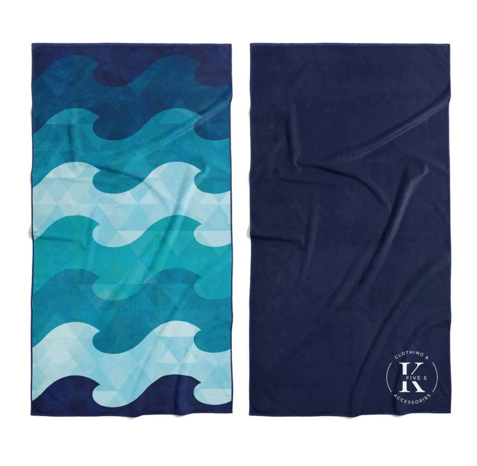Two K5 microfibre beach towels: blue wave/triangle patterns and solid navy, ultra-absorbent.