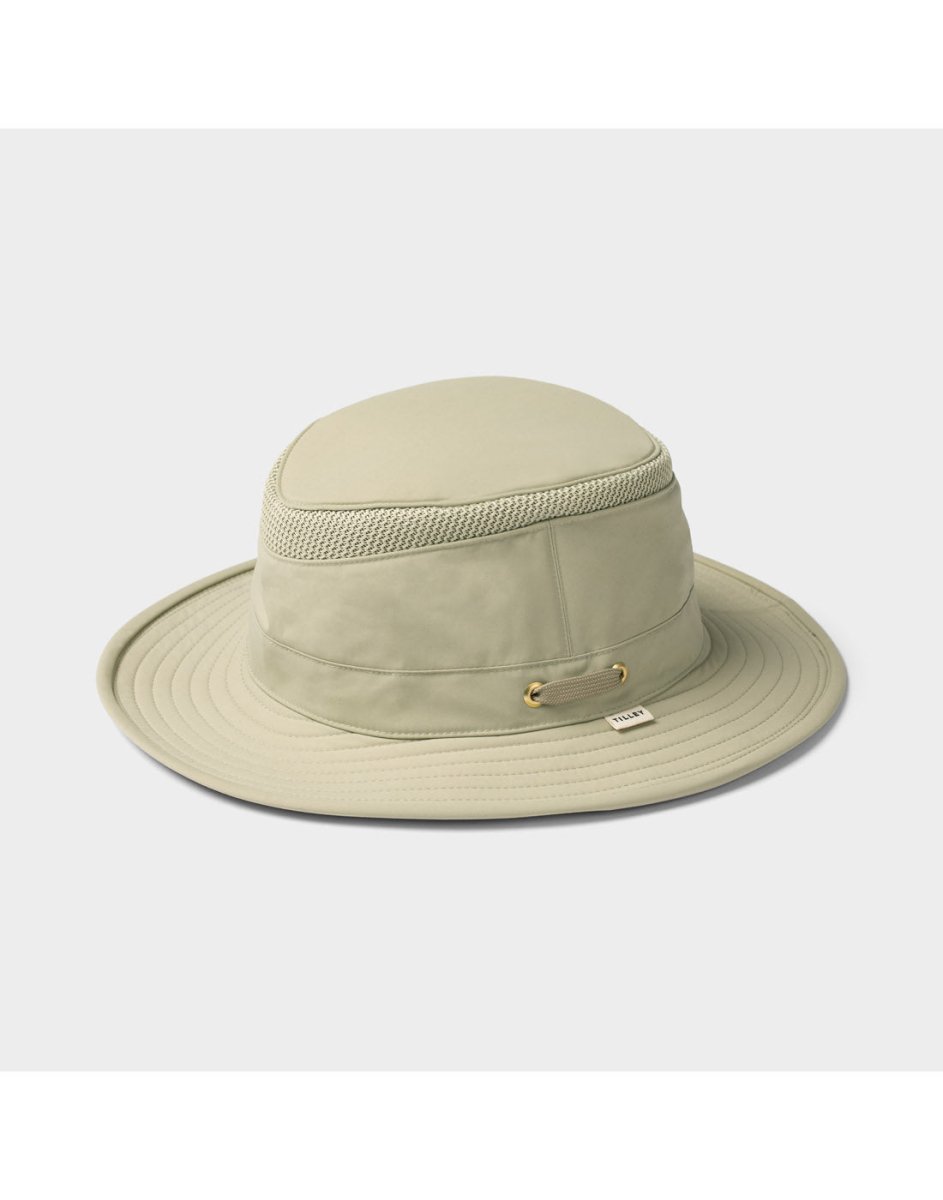 Tilley LTM5 Airflo® Hat by Tilley in light beige, featuring a wide brim and ventilation mesh, on plain background.