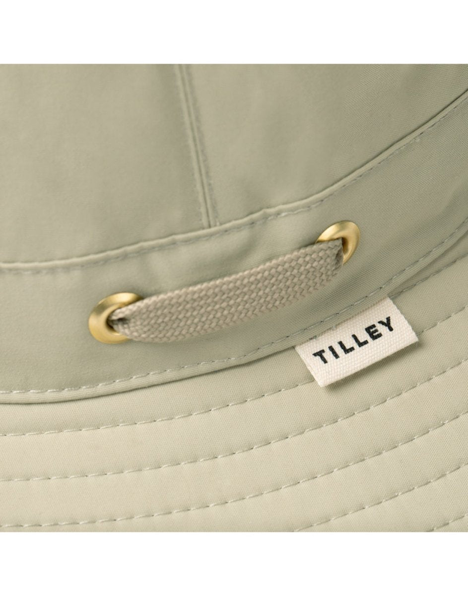 Close-up of the Tilley LTM5 Airflo® Hat in light khaki with brass grommets and visible Tilley tag.