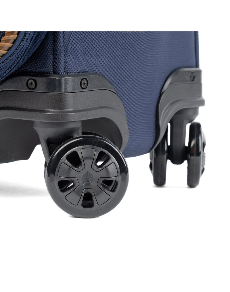 Travelpro Crew™ Classic Carry-on Expandable Spinner in Patriot Blue.  Close-up view of the ultra-durable, 360° MagnaTrac® self-aligning spinner wheels.