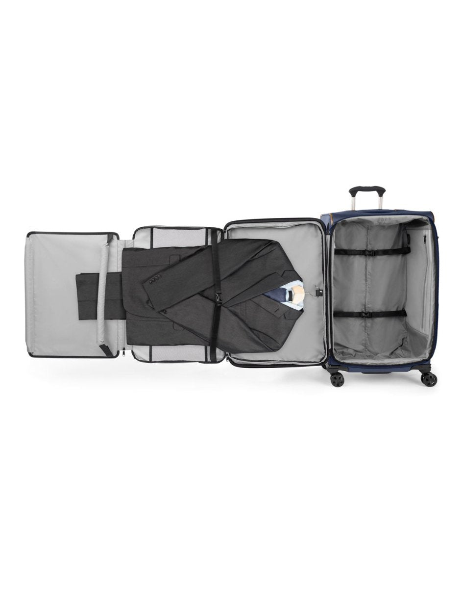 Travelpro Crew™ Classic Large Check-in Expandable Spinner in Patriot Blue. Showing a men's suit laid out on the removable fold-out suiter, which is designed to protect hanging clothes from wrinkles.