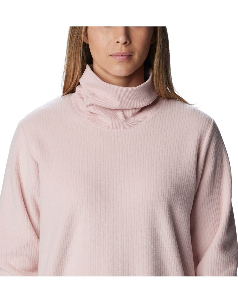 Close-up front view of a woman wearing a Columbia Women's Boundless Trek™ Fleece Dress in Dusty Pink.