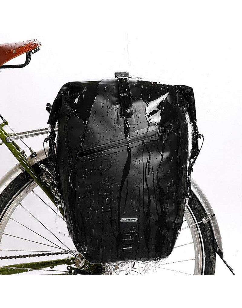Corsino Journey Pannier Bag - black, attached to rear of bike, wet showing waterproof material